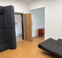 The room has black furniture and a floor with a wood decor, suitable for warehouses and halls.