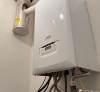 Gas boiler with a piping system on the wall in warehouses and halls.