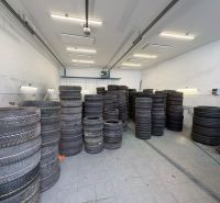 Tires stored in warehouses and halls on a wooden decor floor.