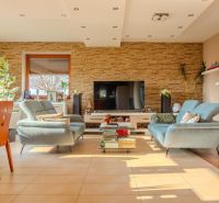 Living room of a family house with a television, stove, and comfortable sofas.