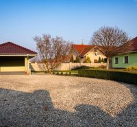 The courtyard of a family house in Dolný Bar with a stone surface and a garage.