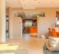 Open concept of a family house with a kitchen, living room, and dining area.