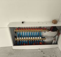 Manifold for underfloor heating in a family house, detailed view of water distribution.