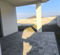 A terrace at a family house in Michal na Ostrove with a tiled floor and a fence.