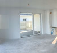 Interior in a family house with large windows and concrete floor.