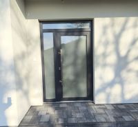 The front door of a family house in Michal na Ostrove with a stone walkway.
