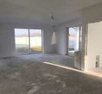 A spacious room with large windows in a family house.