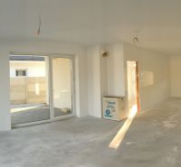 A spacious interior of a family house with large sliding doors and white walls.