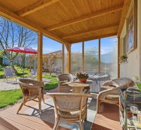 Terrace of a family house in Kostolné Kračany with rattan furniture and garden seating.