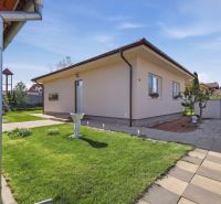 A family house in Kostolné Kračany with a well-maintained garden and outdoor paving.
