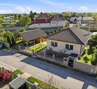 A family house in the village of Kostolné Kračany with a garage and a landscaped garden.