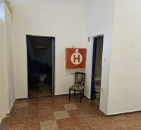 Commercial premises with tiles, folding chairs, and a fire cabinet.