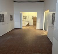 Interior of commercial spaces with tiled floors and decorative tiles on the walls.