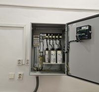 Electrical installation in commercial premises with an open electrical cabinet on the wall.