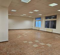 Spacious commercial spaces with tiles and large windows provide plenty of natural light.