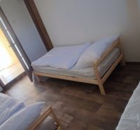 Three beds in a room with a wooden decor floor, Family house.