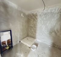 A bathroom under construction in a family house with preparations for sanitary equipment.