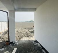The exterior of a family house in Michal na Ostrove with a view of a plowed field.