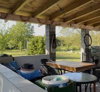 The garden of a family house in Dolný Štál with a terrace and a hanging swing.