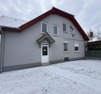 A family house in Dolný Štál with a white facade and a snowy yard.