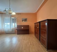 Living room in a family house with a piano and furniture, floor with wooden decor.