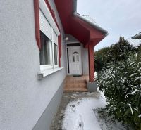 Entrance to a family house in Dolný Štál with white doors and a snow-covered walkway.