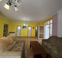 Living room in a family house with comfortable sofas and a wooden decor floor.