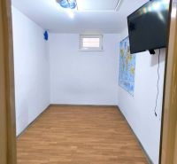 A room in a family house with a map and a wooden decor floor.