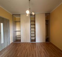 The 1-room apartment has a built-in wardrobe and a floor with a wooden decor.