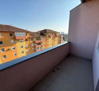 A balcony with a view of colorful buildings in Dunajská Streda, suitable for a 3-room apartment.