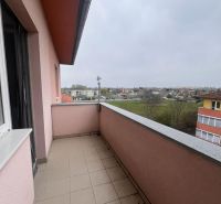 A balcony with a view of the surrounding buildings in a 3-room apartment in Dunajská Streda.