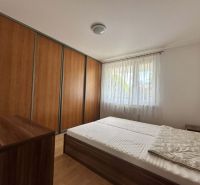 A bedroom in a 3-room apartment with a large wardrobe and a floor with a wooden decor.
