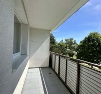 A balcony in a 3-room apartment on the street in Šamorín with a view of greenery.