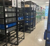 Storage racks with plastic boxes in commercial spaces with tiled flooring.
