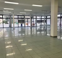 Spacious commercial spaces with glass walls and tiles, ideal for rent.
