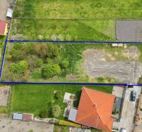 A grassy plot in Horná Potôň suitable for living, surrounded by neighboring plots and buildings.