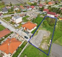 A plot for residential use in Horná Potôň surrounded by houses and greenery.