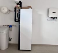 Technical room of a family house with water treatment equipment and a heat pump.
