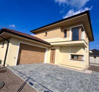 Family house on GARDENTOWN street in Dunajská Streda with garage doors and paving.
