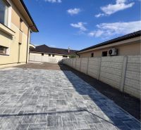 A family house in Dunajská Streda on GARDENTOWN street with a paved courtyard.