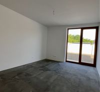 Empty room with a concrete floor and glass doors in a family house.