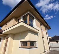Family house on GARDENTOWN Street in Dunajská Streda with a beige facade and glass windows.