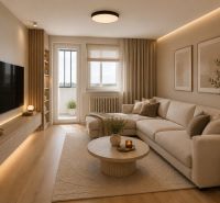 Living room in a three-room apartment with a wooden decor floor and a cream sofa.