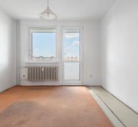 Empty room in a 3-room apartment with a window and a radiator.