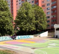 The basketball court on Lachova Street in Bratislava's Petržalka, surrounded by apartment buildings and trees.