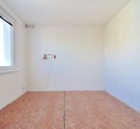 An empty room with a wooden floor in a 3-room apartment.