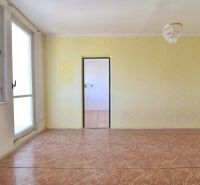 A room in a 3-room apartment with large windows, a chandelier, and a floor with a wooden decor.