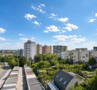 View of apartment buildings and greenery in Bratislava-Rača on Sadmelijská Street.