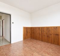 A white room in a 3-room apartment with paneling and wood imitation on the floor.
