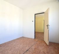 An unfurnished room in a 3-room apartment with a wooden decor floor and a radiator.